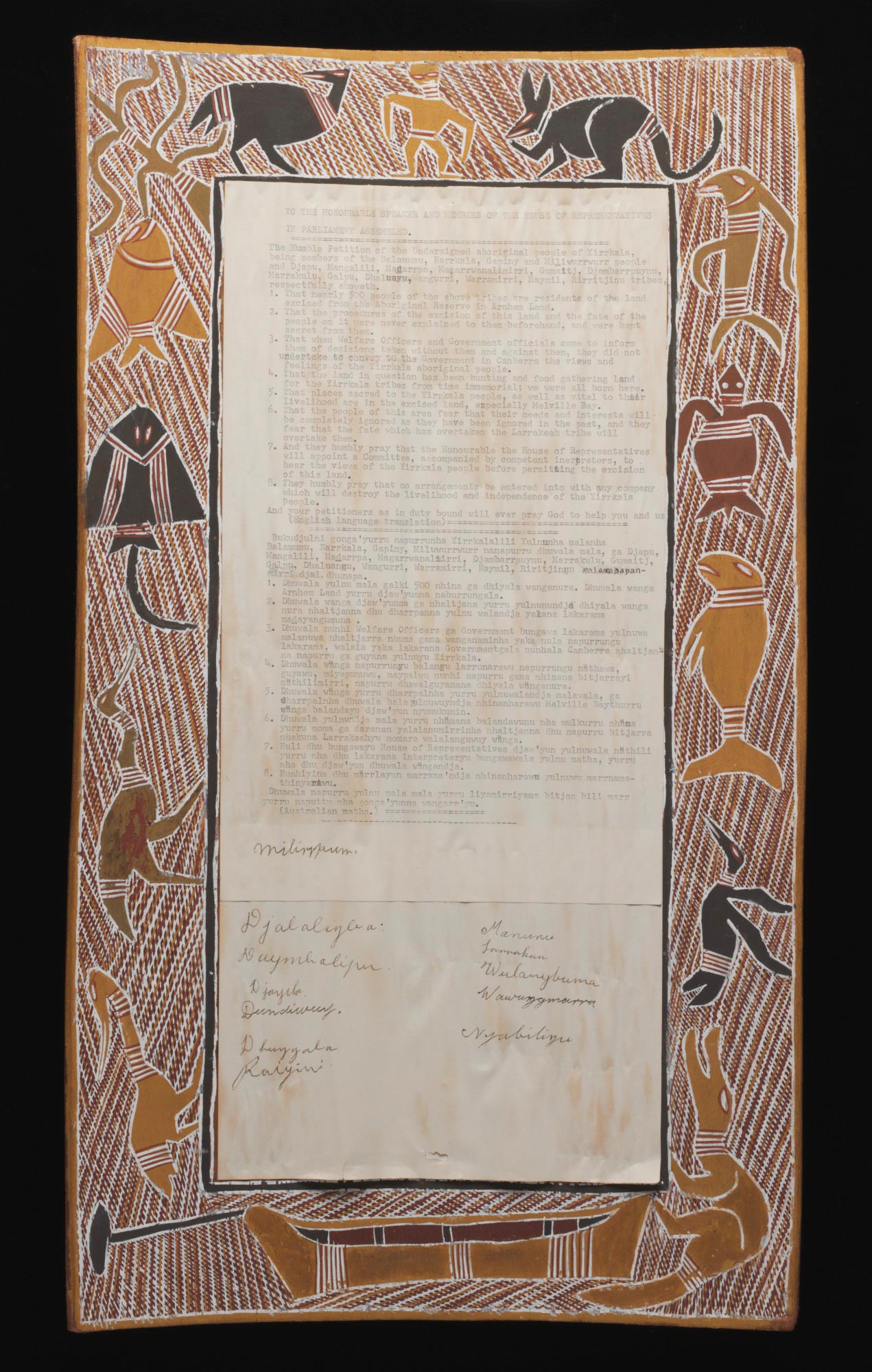 A rectangular bark painting that forms a border around a typed petition on paper. The bark is painted with yellow, white, brown, red, and black ochre. The border depicts a man, a kangaroo, a turtle, a dugong, a crocodile, a stingray, fish, several birds, and a canoe on a background of cross-hatching. The petition is stuck to the centre of the bark and has a heading that reads 'TO THE HONOURABLE SPEAKER AND MEMBERS OF THE HOUSE OF REPRESENTATIVES / IN PARLIAMENT ASSEMBLED...'. There are two blocks of text un