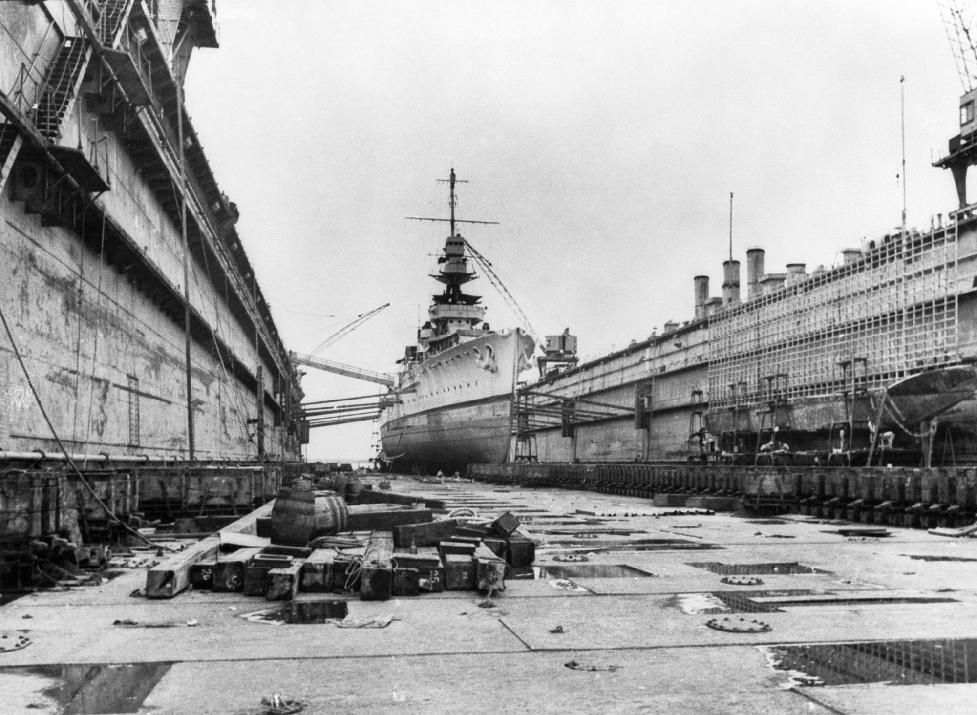 <p>A British warship being refitted in a floating dock at Singapore naval base, 1940s</p>
