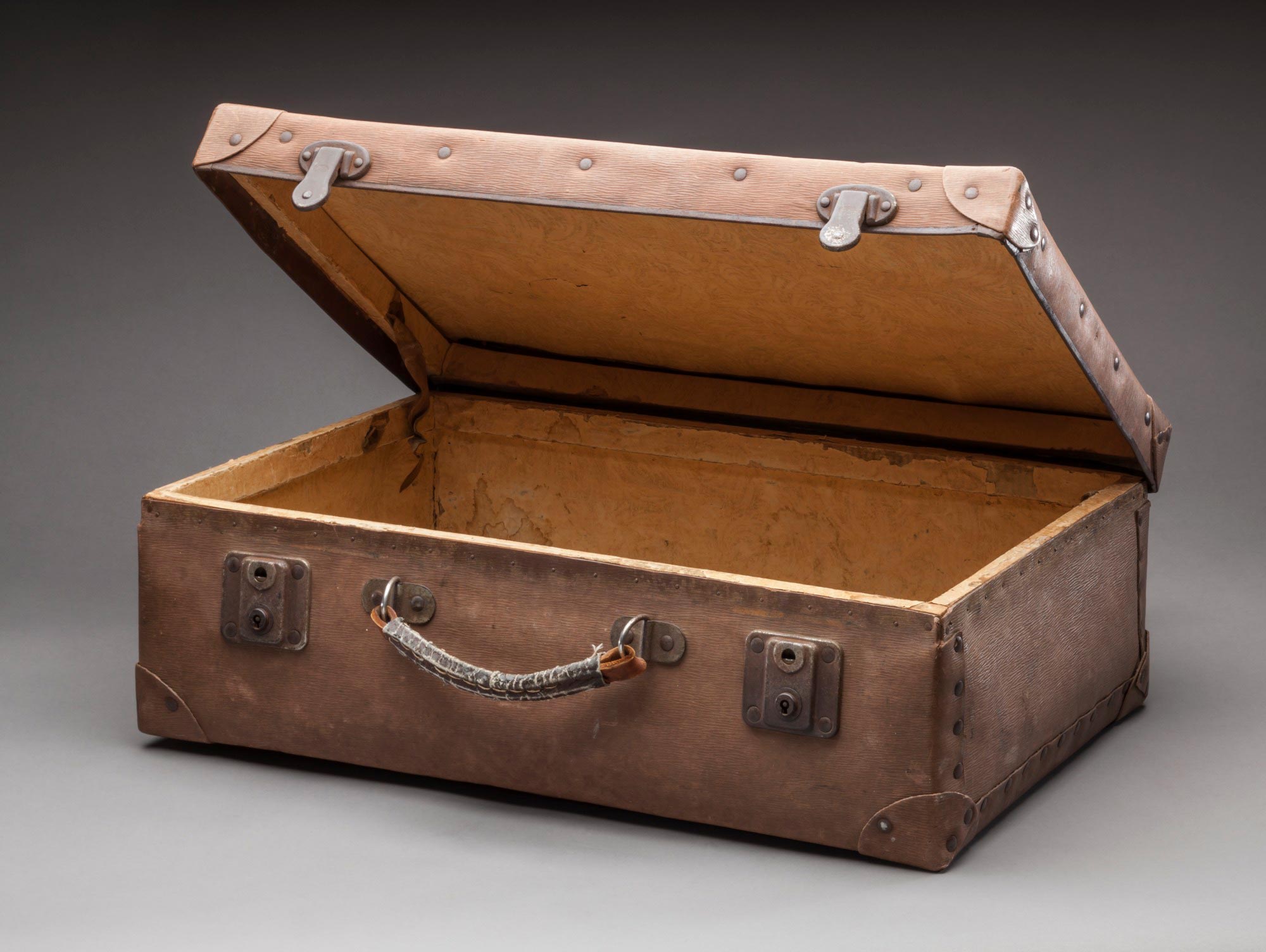 <p>Small brown vinyl suitcase used to transport Mungo Lady’s remains to Canberra</p>
