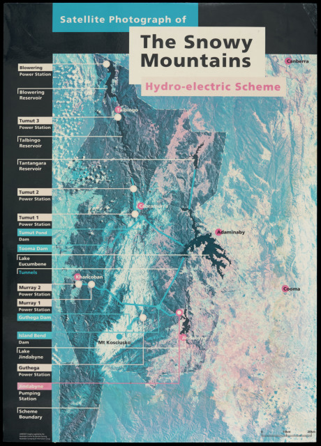 A poster featuring a colour photograph with the caption 'Satellite Photograph of / The Snowy / Mountains / Hydro-electric Scheme', marking out dams, power stations, lakes, pumping stations and boundaries, mounted on foam board. The picture has faded to a shade of blue, with light brown water stains.
