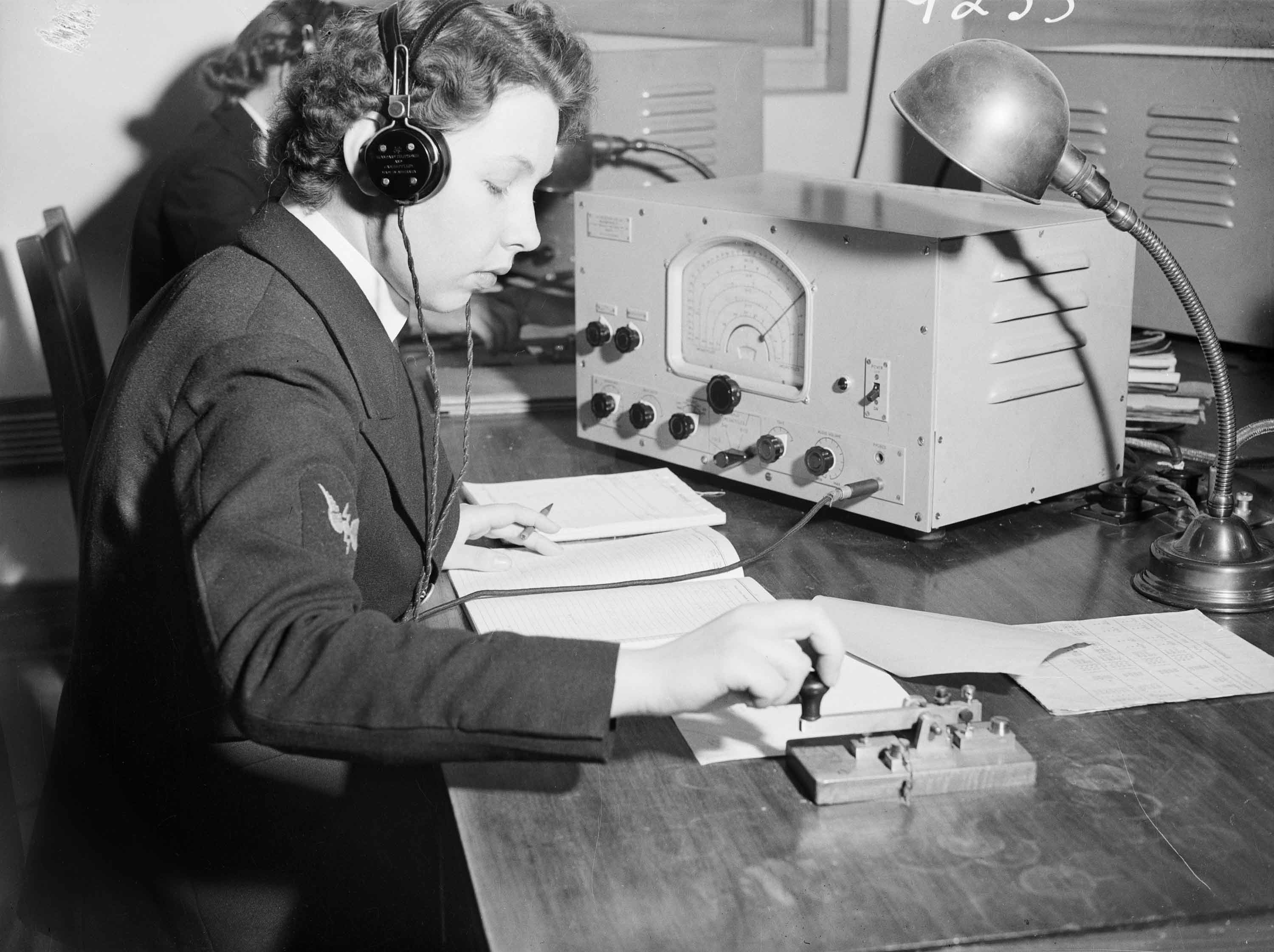<p>A member of the Women’s Royal Australian Naval Service (WRANS) performs signals operations at HMAS <em>Harman</em>.&nbsp;</p>
