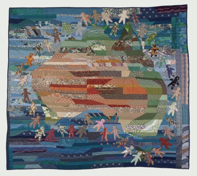 A multi-coloured double bed sized quilt featuring a map of Australia surrounded by human figures.