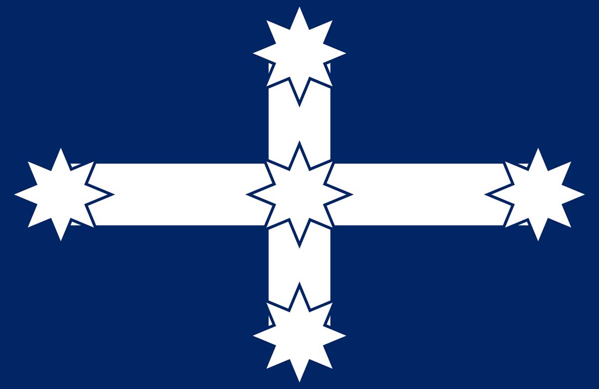 Flag featuring a white cross with star shapes on the ends and centre, against a blue background.