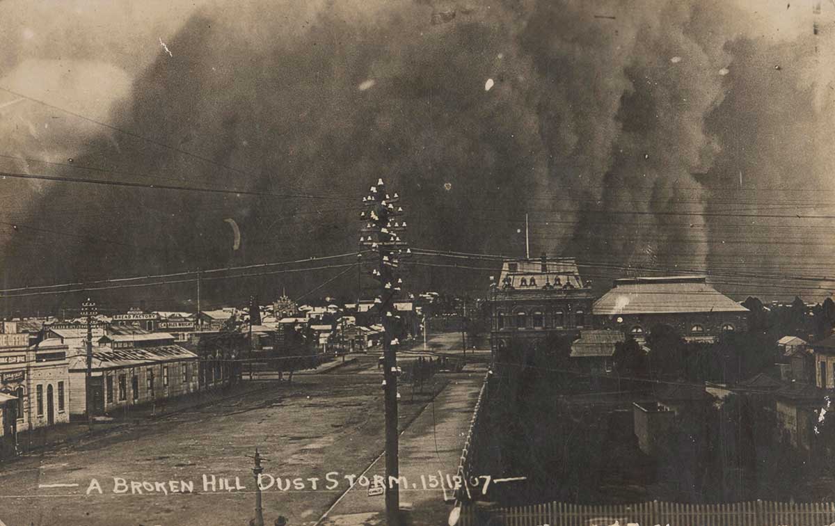 Black and white photograph of a sandstorm over a town.