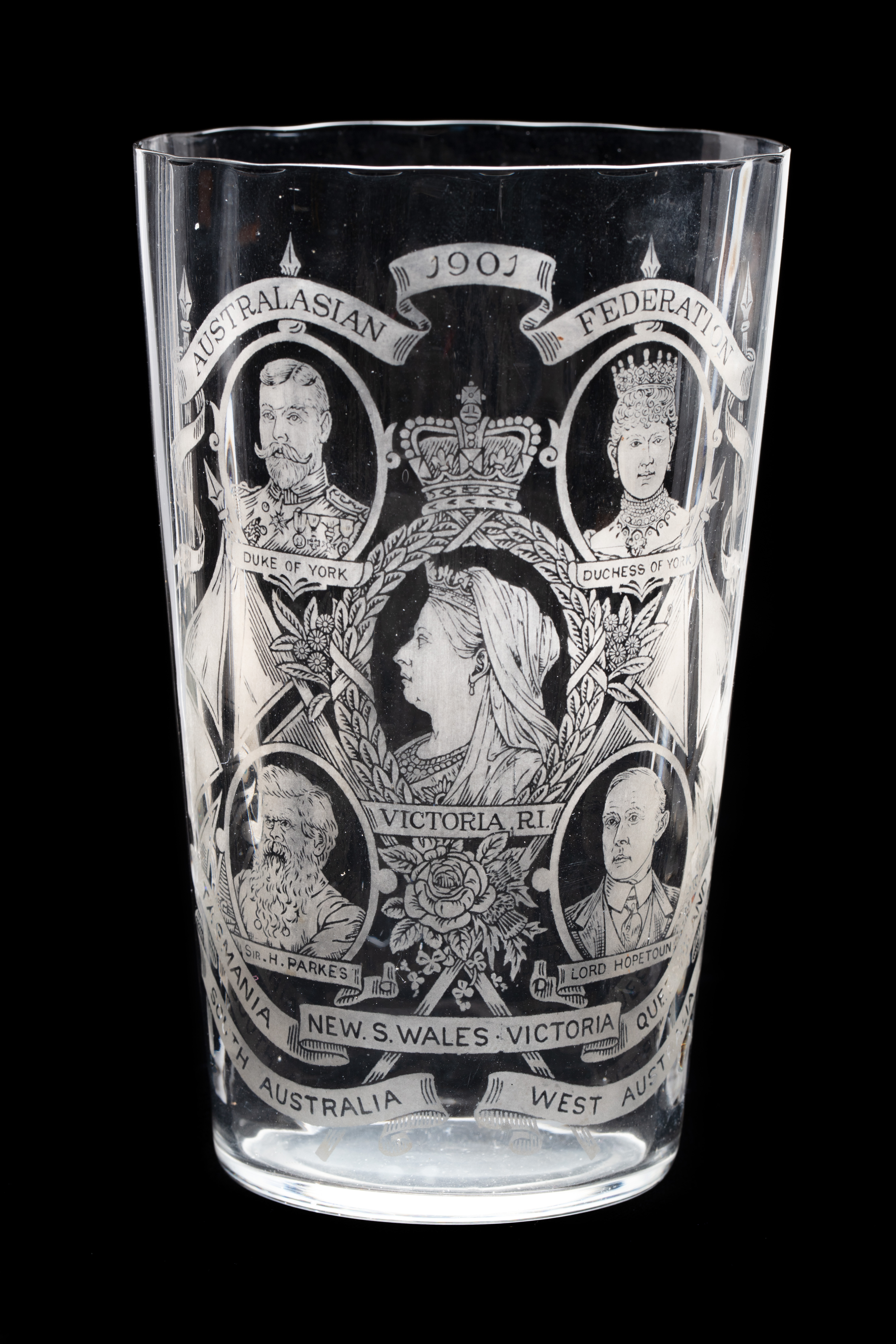  A glass with an etched portrait of Queen Victoria centred inside a wreath border, with the Duke and Duchess of York at the top, and Sir Henry Parkes and Lord Hopetoun at the bottom. 