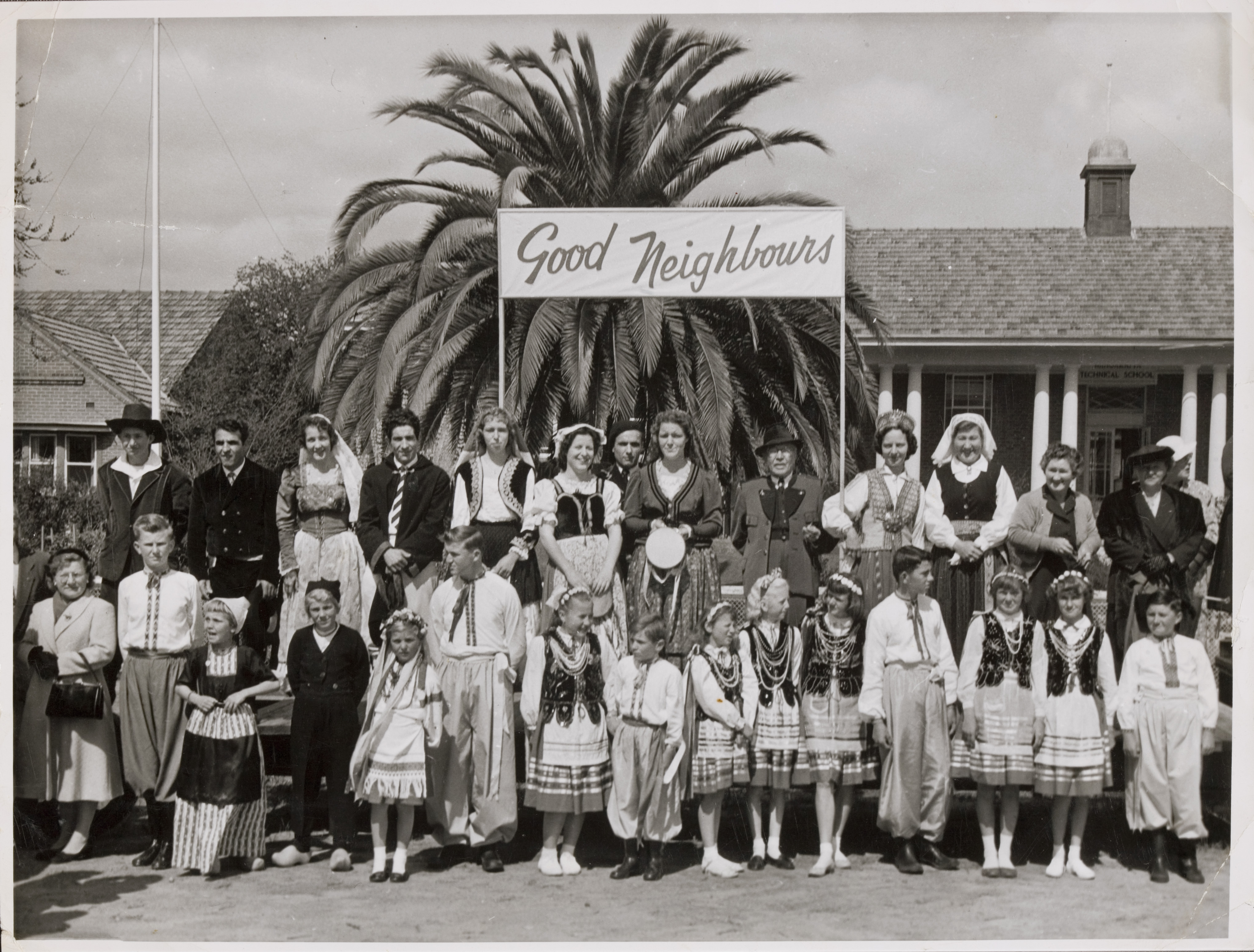  Photo of the Good Neighbour Movement including Guna Kinne wearing her Latvian national dress. They are assembled on Docker Street just around the corner from Mackay Street waiting for the visit of Princess Alexandra on the 16th September 1959.
