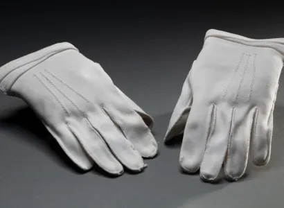 Pair of short white cotton gloves worn by Aboriginal rights activist Faith Bandler.