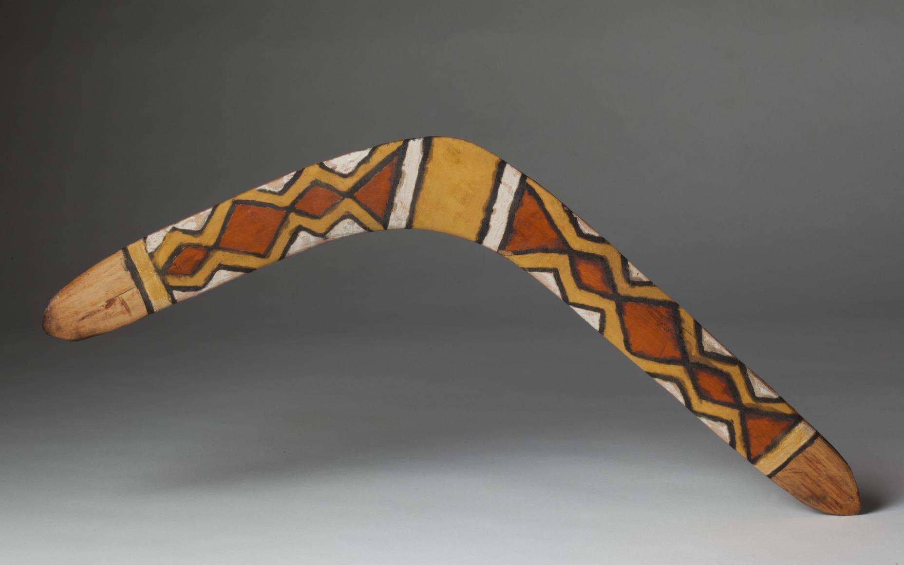Pigmented, wooden boomerang.