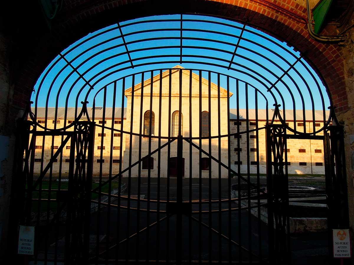 View of a heritage building through arc-shaped gates.